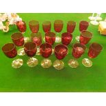 A collection of seventeen 19th century ruby glass bowled wine glasses with plain stems, all of