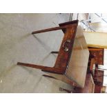 An 18th century Pembroke style drop flap table with bur walnut top and single drawer with drop brass