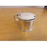 An early 19th century silver drum mustard of plain design with hinged cover, hallmarked London 1804,