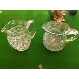 Two early 20th century cut glass water jugs with applied handles.