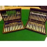 Two oak cases containing 2 sets of 12 place setting fish knives and forks - note one set one fork