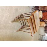 An early 20th century nest of 3 walnut coffee tables with bowed stretchers and splayed legs A/F.