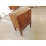 An antique walnut domed top cellaret with drop brass handles and boxwood string coursing.