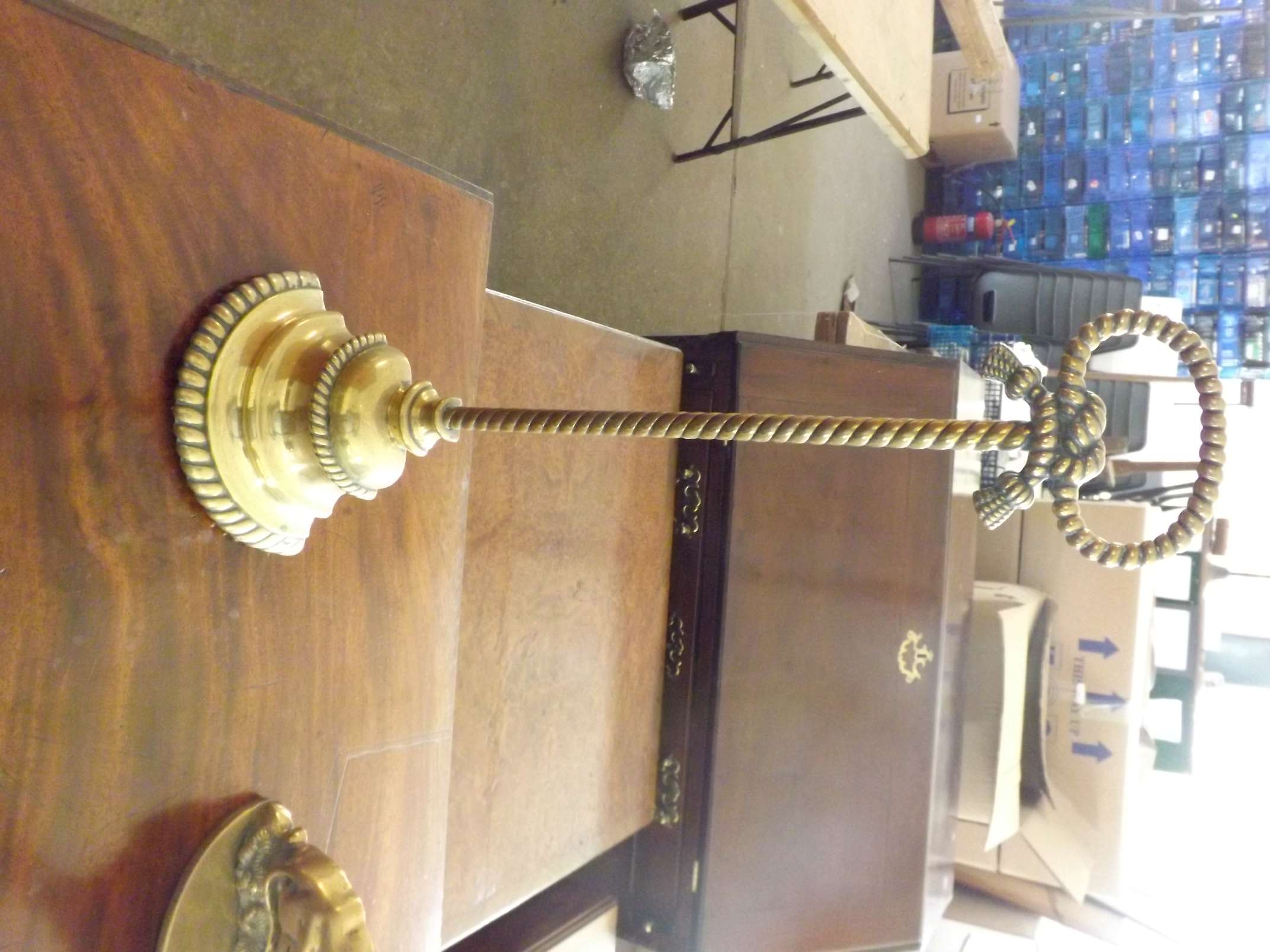 A Victorian cast brass weighted door stop with rope knot design.