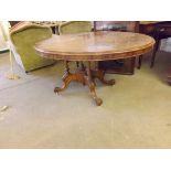 A mid 19th century oval tip top walnut breakfast table marked on the base "Hooke, Peterborough"