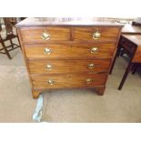 A Georgian chest of 3 long and 2 short drawers with oval drop brass handles having Prince of Wales