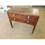 A small antique side table with one long and 2 short drawers with Regency style circular brass