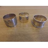 Two silver napkin rings and an Elkington plated napkin ring.