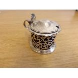 A silver cylindrical mustard pot with openwork decoration and blue glass liner, hallmarked Sheffield