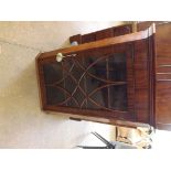 A Georgian mahogany hanging corner cupboard with 3 shelves and shaped glazed door.