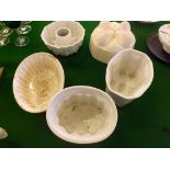 Four 19th century white pottery jelly moulds depicting Sheaf of Corn, rabbits, Cathedral, etc.,