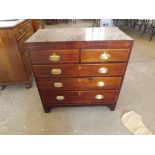 An antique mahogany cross-banded chest of 3 long and 2 short drawers with oval drop brass handles