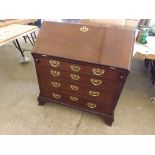 A mid 18th century red walnut bureau, the shaped interior with columns, door and secret drawers with