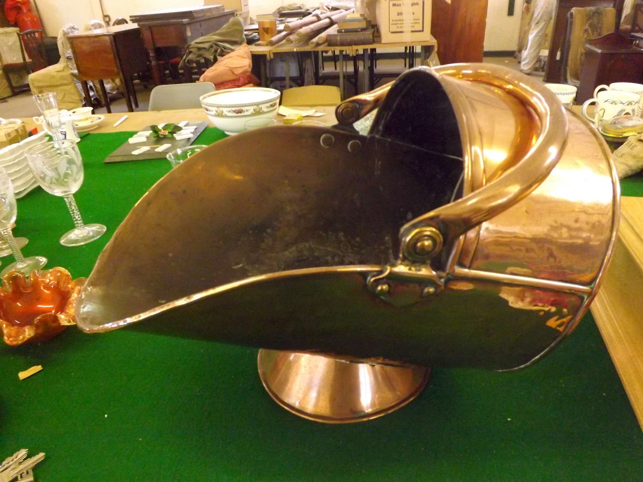 A large antique copper coal helmet with swing handle.