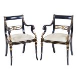 A pair of ebonized and gilt wood armchairs 20th century 84x58x57 cm.