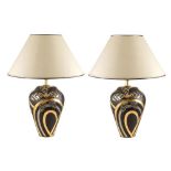 A pair of table lamps in black and golden ceramic 20th century h. 59 cm.