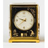 Le Coultre Atmos Clock with Asian Motif.Mid 20th century.Ht. 9 1/2" W 7".Online bidding available: