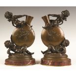 Auguste Moreau (French, 1834-1917) Bronze Cherub Vases with Marble Bases.Signed Auguste Moreau.