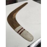 A hardwood boomerang with painted decoration.