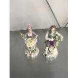 A pair of German porcelain figures "Gardeners" in classical dress.