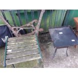 A cast iron garden stool together with two bench ends and a small fire pit.