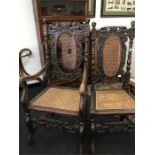 Two 19th century dining room chairs, one side, one carver, both being heavily carved with cane