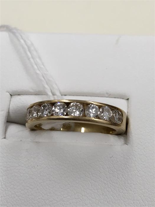 A 14kt gold ladies channel set 10 stone diamond ring.Stones are I/J in colour and SI clarity.