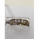 A 14kt gold ladies channel set 10 stone diamond ring.Stones are I/J in colour and SI clarity.