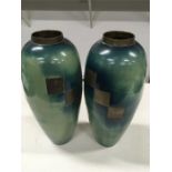 A pair of 20th century WMF style bronze ovoid shaped vases, decorated in tones of blue and green.