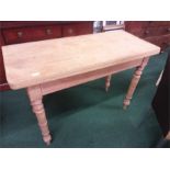 A pine fold-over kitchen table .