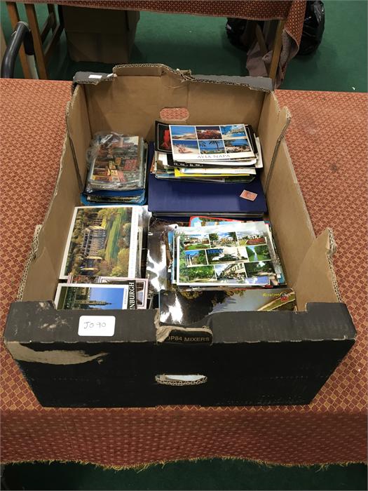 A box containing a large quantity of mainly modern postcards both used and unused.