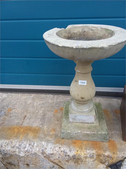 A stone bird bath in three sections.