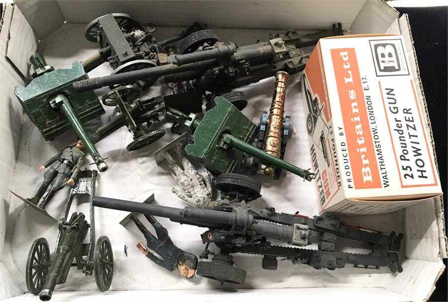 A collection of 7 x Britains and other mobile and Field Guns and 4 x figures on Brass mounts. A Near