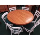 A circular blockwood kitchen table and six chairs.