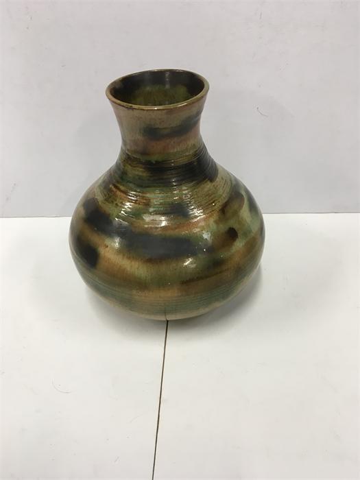 An 8" Studio vase in a green and brown slip-trailed design together with a German Pottery vase in