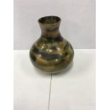 An 8" Studio vase in a green and brown slip-trailed design together with a German Pottery vase in