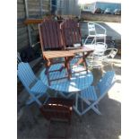 A blue painted garden table and six chairs.