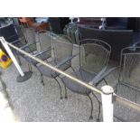 A set of six metal garden armchairs.