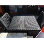 A plastic weave snap top garden table and three chairs.