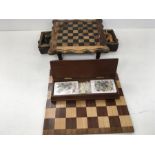 An ornate chess board with drawers under together with other items.