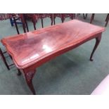 A mahogany glazed top coffee table.