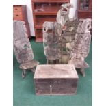 A group of African log chairs together with a box.