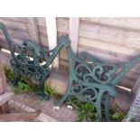 Two pairs of cast iron bench ends.
