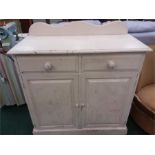 A white painted pine cupboard with two drawers to top.