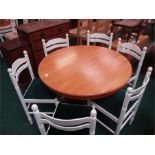 A circular blockwood kitchen table and six chairs.