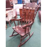 A large slat back rocking chair.