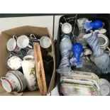 A suitcase containing glassware and various china together with pictures.