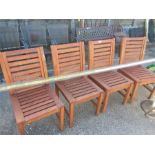 A set of four teak garden chairs.