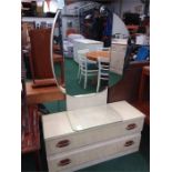 A retro dressing table with two drawers below with large circular vanity mirror to top.