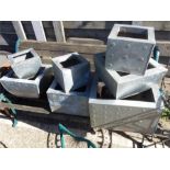 A set of seven various sized metal planters.